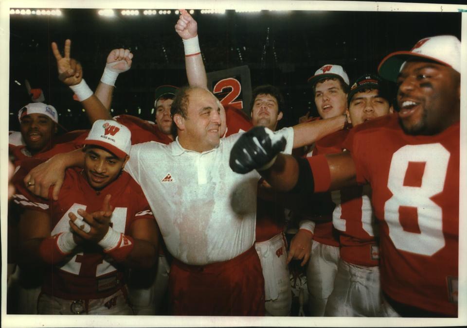 Wisconsin head coach Barry Alvarez celebrates with his players after a 41-20 victory over Michigan State in Tokyo on Dec. 5, 1993, before moving on face UCLA in the Rose Bowl on Jan. 4, 1994.