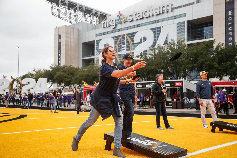 Christy Sullivan of Pittsburgh and Dave Rodgers of Augusta, Maine play a game of corn hole during pregame festivities before the national championship game at NRG Stadium in Houston on Monday, Jan. 8, 2024.