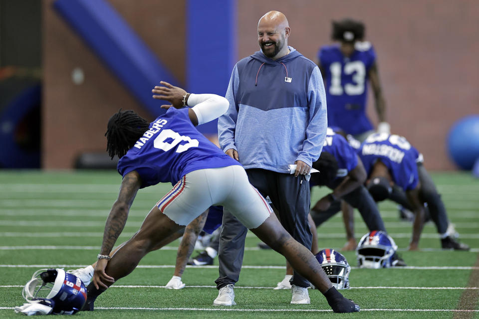 New York Giants head coach Brian Daboll talks with Malik Nabers during an NFL football practice Thursday, May 23, 2024, in East Rutherford, N.J. (AP Photo/Adam Hunger)