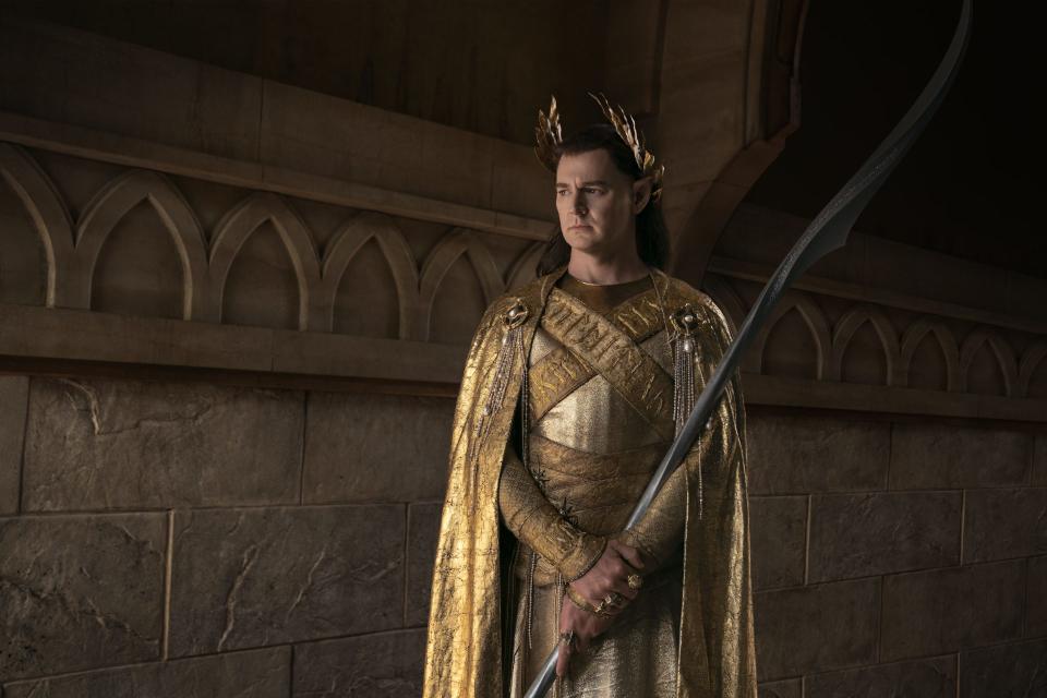 Gil-galad stands armed for battle in golden robes in this exclusive image from The Lord of the Rings: The Rings of Power
