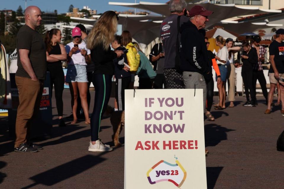 Voters queue up outside a polling station on Bondi Beach in Sydney on Saturday as polls open in Australia's Voice to Parliament referendum.