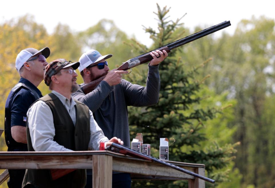 Pat Lieske, left, 58, of Davison and David Olshansky, center, 53 of Walled Lake look on as Lions offensive lineman Frank Ragnow competes during a skeet shooting competition during Ragnow's Skeet Shoot Showdown at the Michigan Shooting Center at Bald Mountain in Lake Orion on Thursday, May 18, 2023.