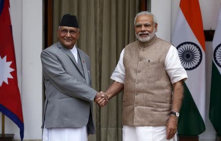 Nepal's Prime Minister Khadga Prasad Sharma Oli (L) shakes hands with his Indian counterpart Narendra Modi during a photo opportunity ahead of their meeting at Hyderabad House in New Delhi, India, February 20, 2016. REUTERS/Adnan Abidi