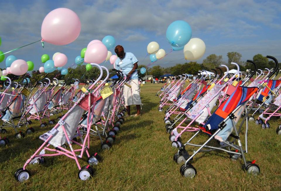 2007: Kaemah Cooper ties balloons to baby strollers during the 2nd Annual Stroller-Thon at Eastover Park in east Fort Worth. The 177 strollers represented the number of infant deaths in Tarrant County in 2004