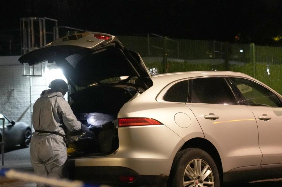 Forensic teams searched a car on the scene on Tuesday night (James Weech/PA Wire)