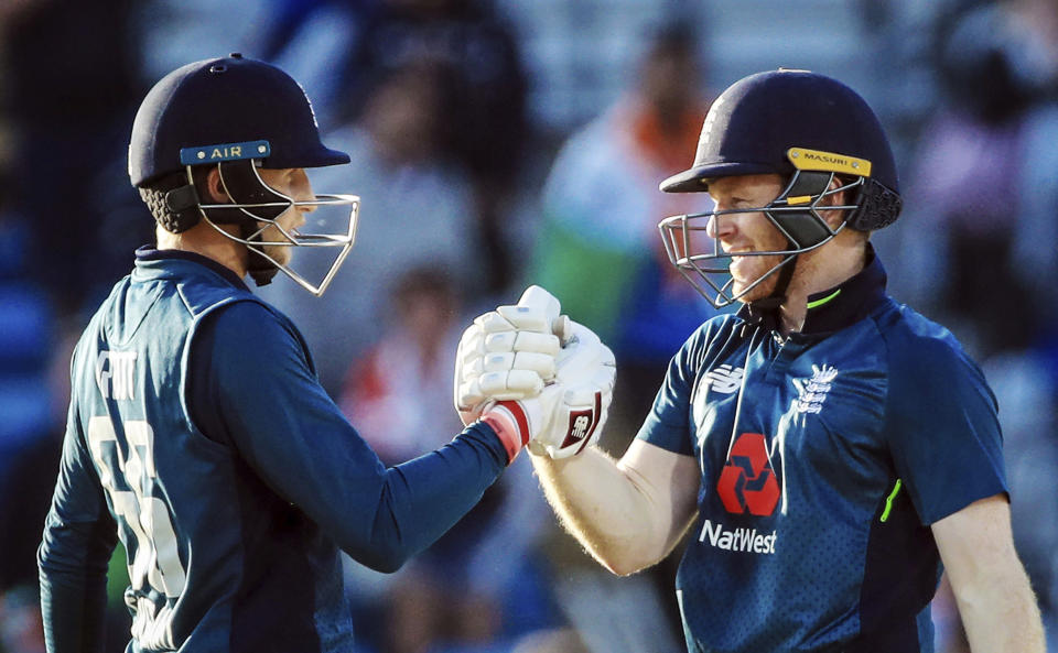 England’s Joe Root, left, celebrates making his century to win the match with team mate Eoin Morgan, during the third One Day international against India, at Headingley in Leeds, England, Tuesday July 17, 2018. (Danny Lawson/PA via AP)