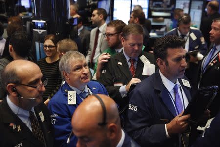 Traders work on the floor of the New York Stock Exchange (NYSE) shortly after the opening bell in New York, U.S., October 17, 2016. REUTERS/Lucas Jackson