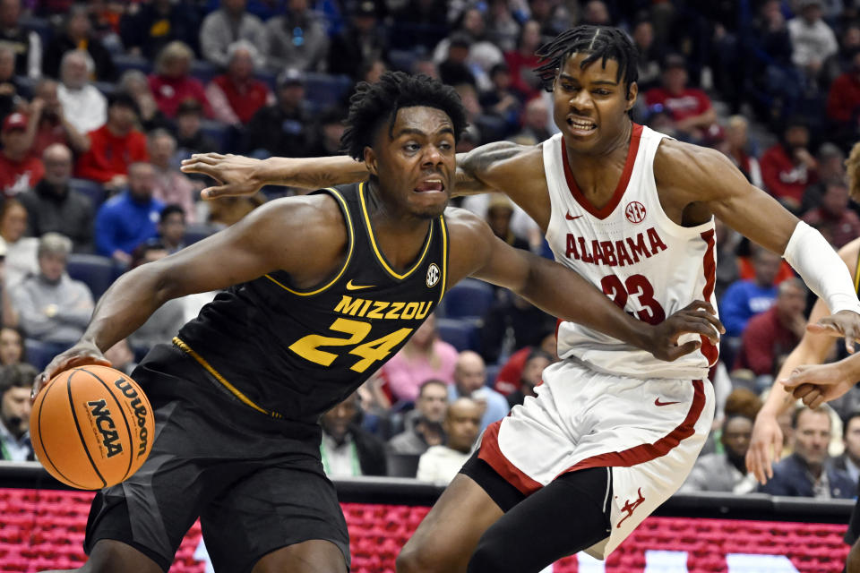 Missouri guard Kobe Brown (24) fends off Alabama forward Nick Pringle during the first half of an NCAA college basketball game in the semifinals of the Southeastern Conference Tournament, Saturday, March 11, 2023, in Nashville, Tenn. (AP Photo/John Amis)