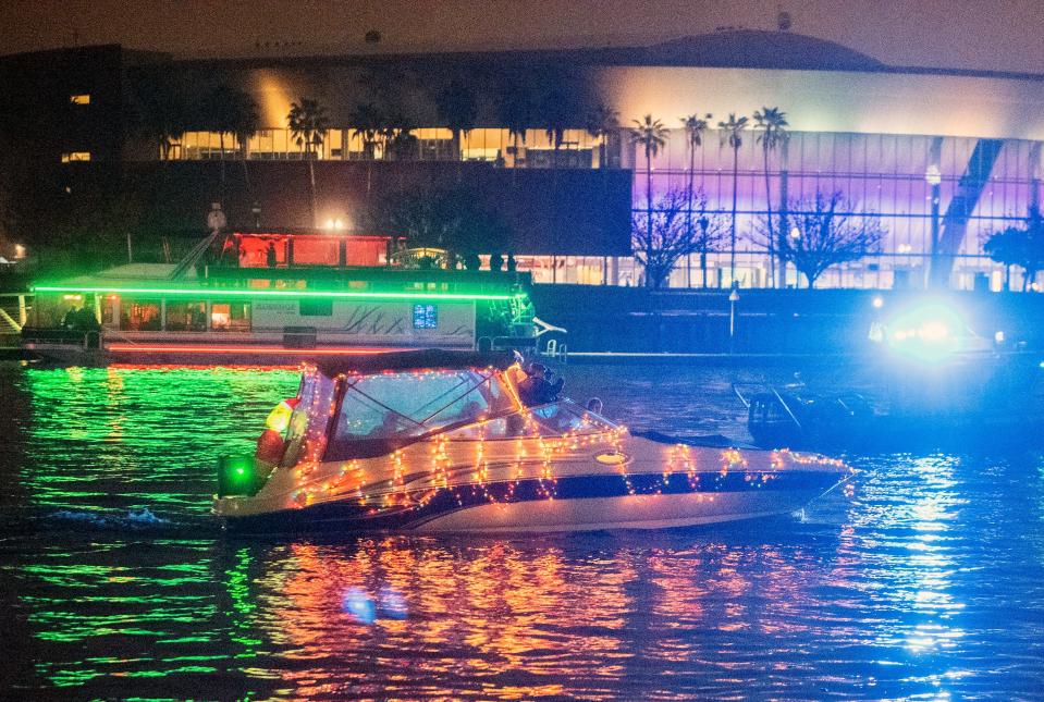 Boats adorned with Christmas lights traverse McLeod Lake at the head of the Deep Water Channel during the Stockton Yacht Club's annual Lynn Hahn Memorial, Delta Reflections Christmas Lighted Boat Parade in downtown Stockton on Saturday, Dec. 3, 2022.