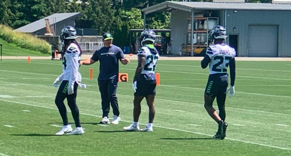 Coach Mike Macdonald talks to cornerback Tre Brown (22) during a Seahawks minicamp practice at the team’s Virginia Mason Athletic Center in Renton, June 12, 2024.