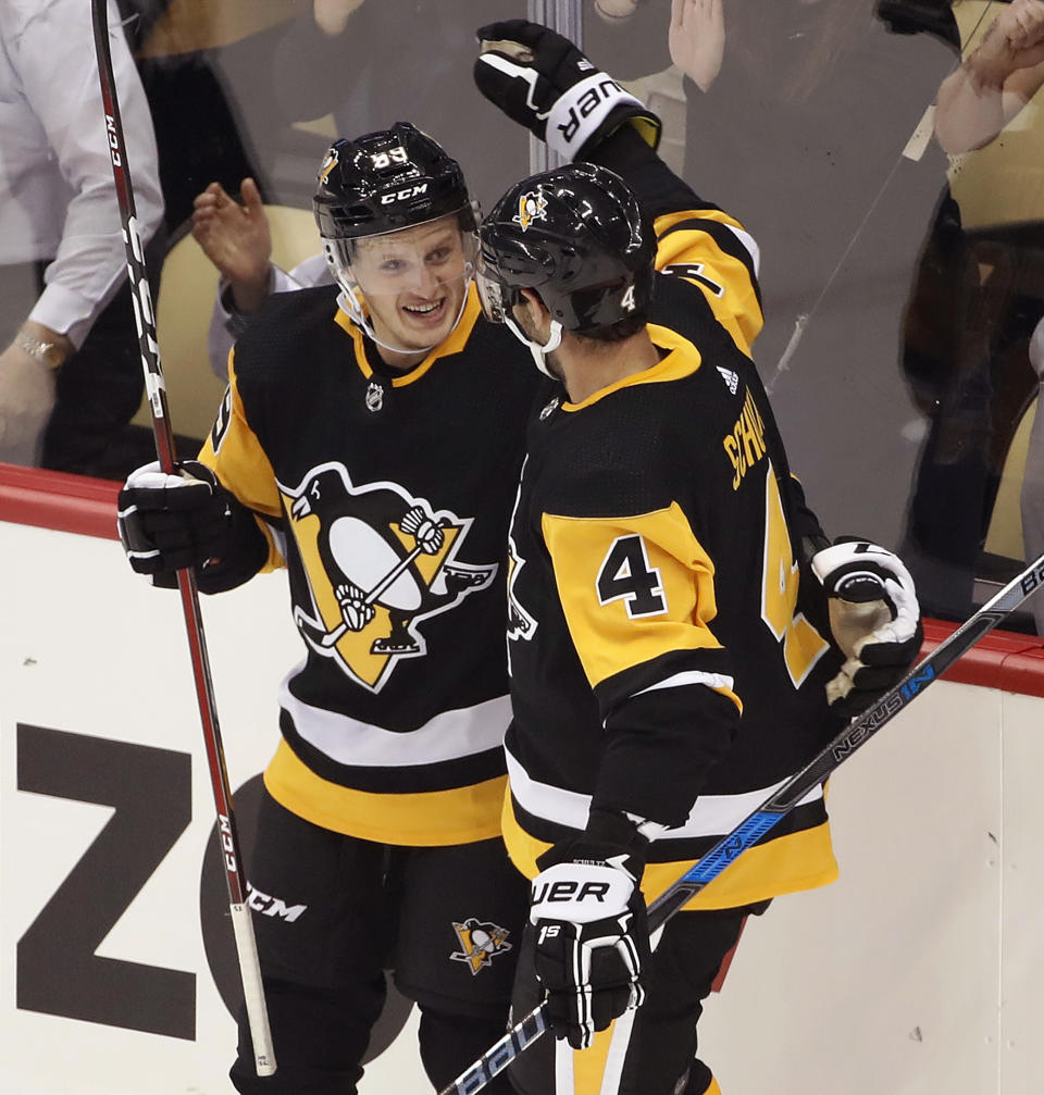 Pittsburgh Penguins' Jake Guentzel (59) celebrates his goal with Justin Schultz during the first period of an NHL hockey game against the Washington Capitals in Pittsburgh, Thursday, Oct. 4, 2018. (AP Photo/Gene J. Puskar)