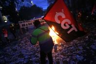 A protester holds a CGT trade union flag during a protest in Madrid November 4, 2013. Spain's labour unions called for an indefinite strike from Tuesday in Spain's capital for the street cleaning and park maintenance sectors in protest against announced layoffs that could affect around a thousand municipal workers, according to local media. (REUTERS/Juan Medina)