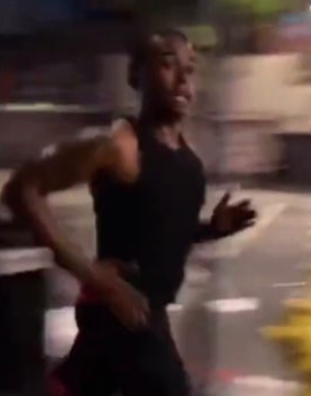 Pictured is a man running in an image released by police.