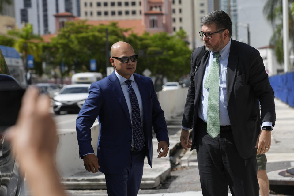 Walt Nauta, left, a valet to former President Donald Trump who is charged with helping the ex-president hide classified documents the Justice Department wanted back, arrives with defense attorney Stanley Woodward at the James Lawrence King Federal Justice Building for his arraignment, in Miami, Thursday, July 6, 2023. (AP Photo/Rebecca Blackwell)