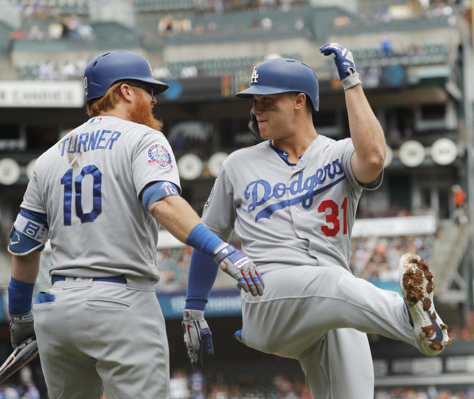 Los Angeles Dodgers' Joc Pederson (31) celebrates scoring a home run with Justin Turner (10) during the first inning of a baseball game in San Francisco, Saturday, Sept. 29, 2018. (AP Photo/Jim Gensheimer)