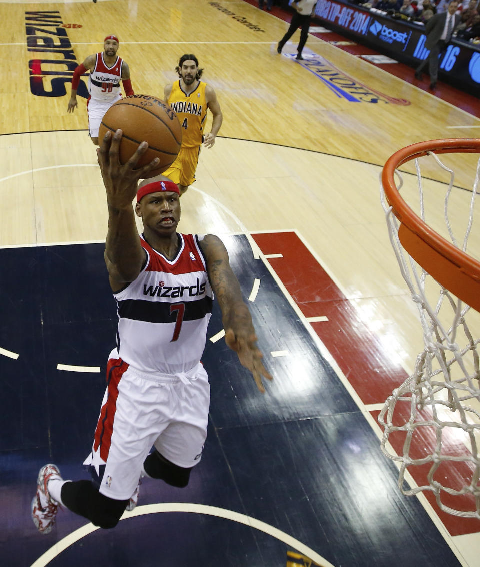 Washington Wizards forward Al Harrington (7) sails toward the basket as Indiana Pacers forward Luis Scola from Argentina (4) looks on during the first half of Game 4 of an Eastern Conference semifinal NBA basketball playoff game in Washington, Sunday, May 11, 2014. (AP Photo/Alex Brandon)