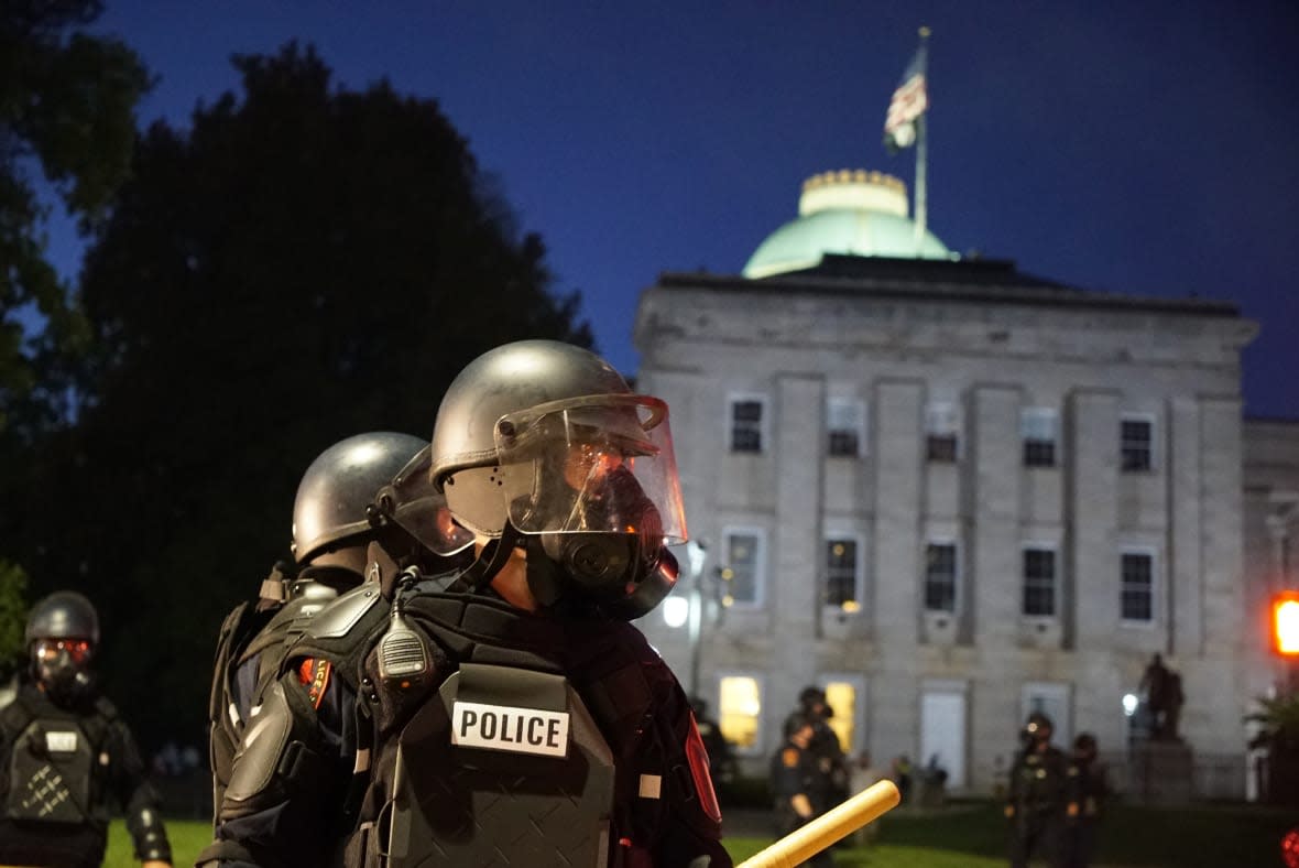 Police in riot gear protect the old state capitol building in Raleigh, N.C., on May 31, 2020. (AP Photo/Allen G. Breed, File)