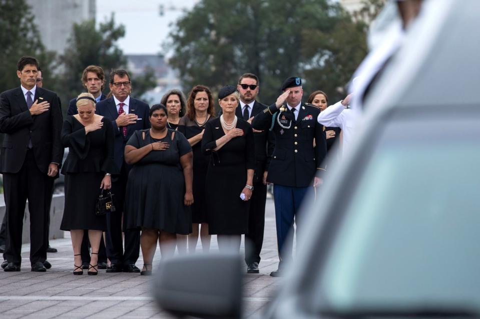 19) Members of the McCain family watch as the casket of Senator John McCain is transferred from the Capitol to the motorcade that will take him to the National Cathedral.