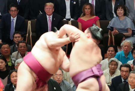 Japanese Prime Minister Shinzo Abe and U.S. President Donald Trump, with their wives Melania Trump and Akie Abe, watch sumo wrestlers compete in the Summer Grand Sumo Tournament at Ryogoku Kokigikan Sumo Hall in Tokyo, Japan May 26, 2019. REUTERS/Jonathan Ernst