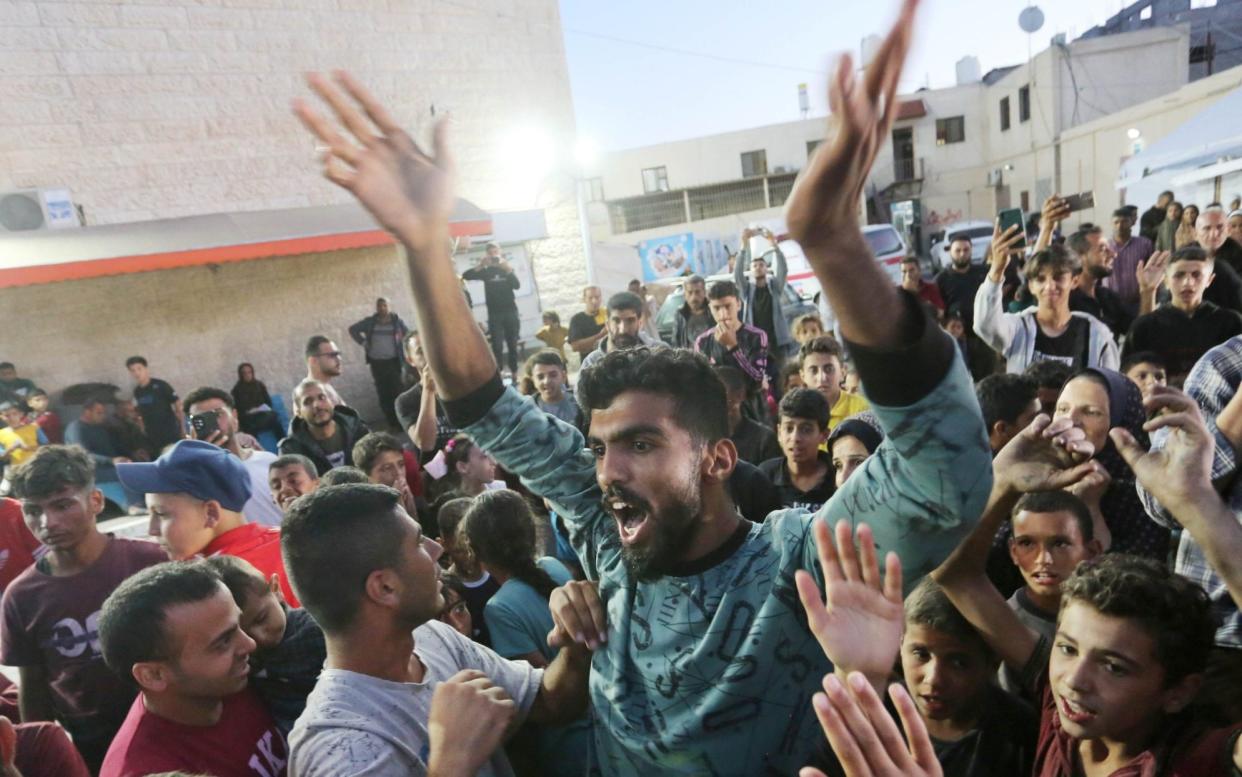 Palestinians celebrate in central Gaza after Hamas informed Qatar and Egypt that it had approved their proposals for a ceasefire