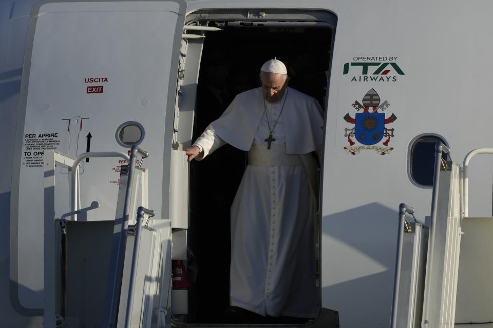 Pope Francis arrives at the airport in Larnaca, Cyprus, Thursday, Dec. 2, 2021. Pope Francis' trip to Cyprus and Greece is drawing new attention to the plight of migrants on Europe's borders and the disconnect between Francis' Gospel-driven call for countries to welcome and integrate them and front-line governments that are increasingly unwilling or unable to let them in. (AP Photo/Alessandra Tarantino)