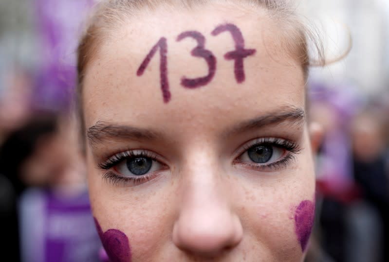 People attend a demonstration to protest femicide and violence against women in Paris