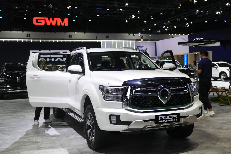 Visitors look at Great Wall Motor's electric vehicle "Poer Sahar" pickup truck during the 45th Bangkok Motor Show in Nonthaburi, Thailand, Tuesday, March 26, 2024. (AP Photo/Sakchai Lalit)