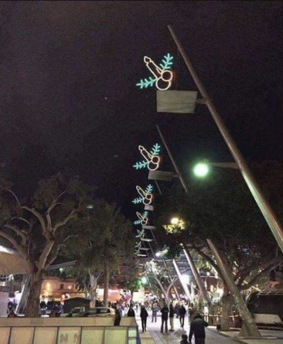 Streetlights that are supposed to be candles and pine branches but look like penises and scrota