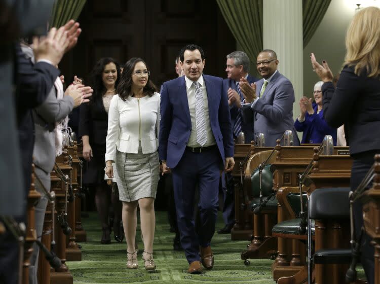 Assemblyman Anthony Rendon, D-Paramount, and his wife, Annie Lam, walk down the center isle of the Assembly during ceremonies where is was sworn-in as the 70th Speaker of the California Assembly, Monday, March 7, 2016, in Sacramento, Calif. Rendon replaces Toni Atkins, D-San Diego, who be leaving office due to term limits at the end of this year's legislative session.(AP Photo/Rich Pedroncelli)