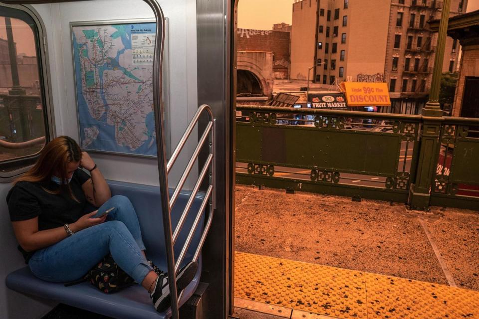 PHOTO: In this June 7, 2023, file photo, a person on the subway wears a facial mask as smoky haze from wildfires in Canada blankets a neighborhood in the Bronx borough of New York. (David Dee Delgado/Getty Images)