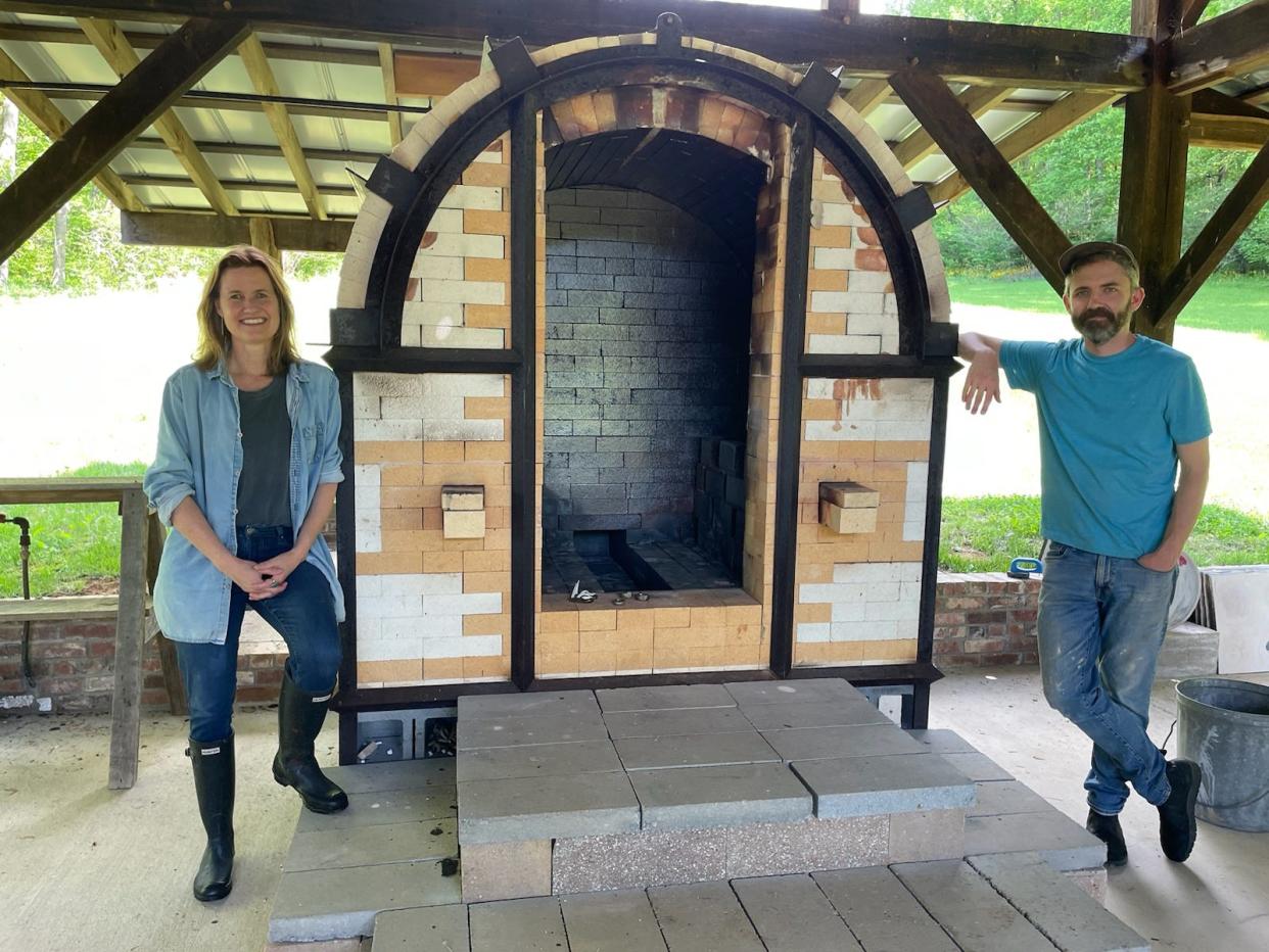 Marjorie Dial and lead resident Bill Jones pose by the salt kiln.