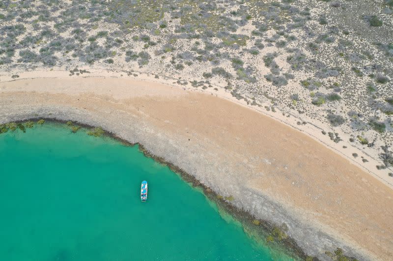 Aerial photo shows a vessel from Deep History of Sea Country surveying Dampier Archipelago in Western Australia