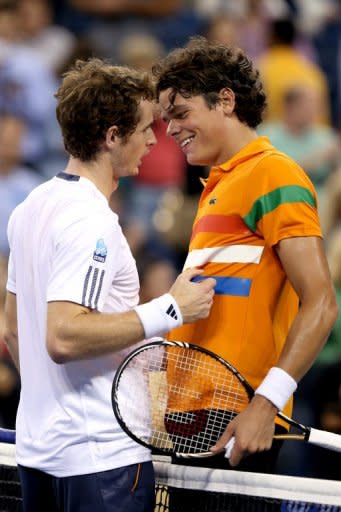 Andy Murray of Great Britain is congratulated by Milos Raonic of Canada after their match at the 2012 US Open September 3, 2012 in New York City