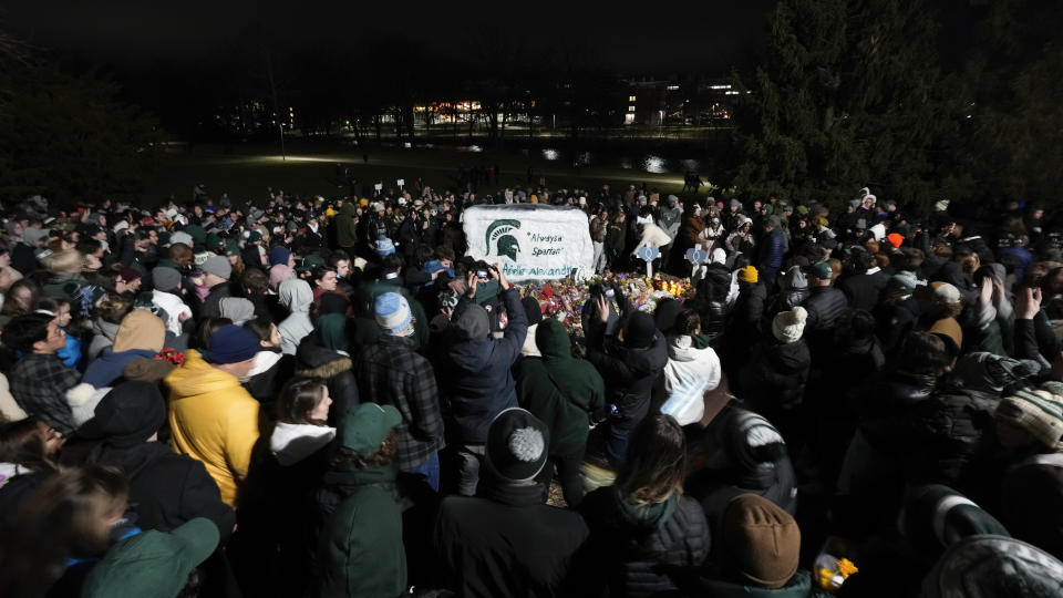 Mourners attend a vigil at The Rock on the grounds of Michigan State University in East Lansing, Mich., Wednesday, Feb. 15, 2023. Alexandria Verner, Brian Fraser and Arielle Anderson were killed and several other students remain in critical condition after a gunman opened fire on the campus of Michigan State University Monday night. (AP Photo/Paul Sancya)