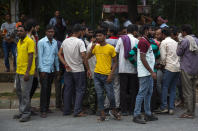 People from northern states crowd the labor chowk - a bazaar at the junction of four roads where hundreds of workers gather daily at daybreak to plead for work in Manesar Industrial Area, Haryana state, India, Aug. 4, 2022. Scenes like this are an everyday reality for millions of Indians, the most visible signs of economic distress in a country where raging unemployment is worsening insecurity and inequality between the rich and poor. (AP Photo/Bhumika Saraswati)