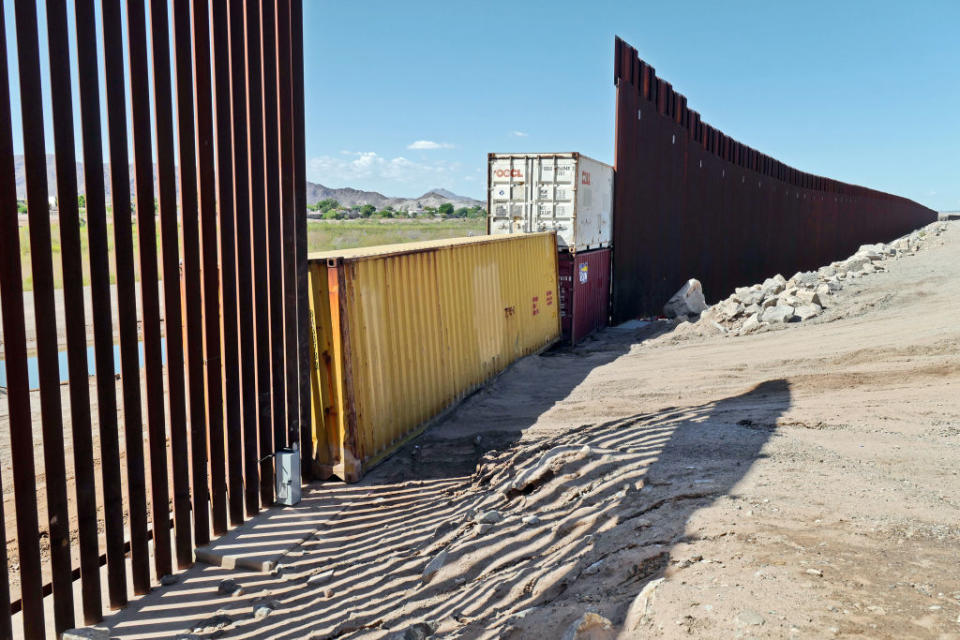 Shipping containers block a void in the wall as that prevent migrants attempting to cross in to the U.S. from Mexico at the border Aug. 19, 2022 in San Luis, Arizona.<span class="copyright">Photo by Nick Ut—Getty Images</span>