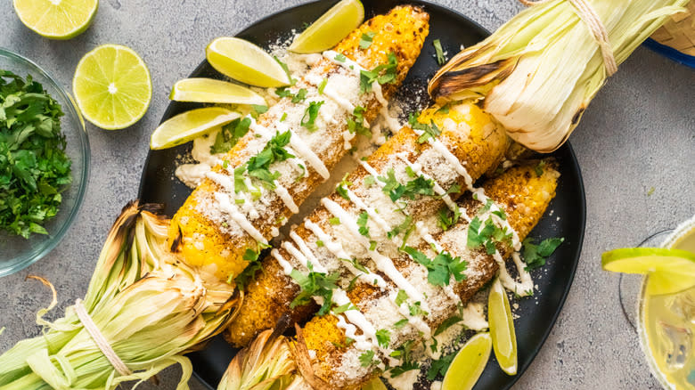 Elote on a black plate 