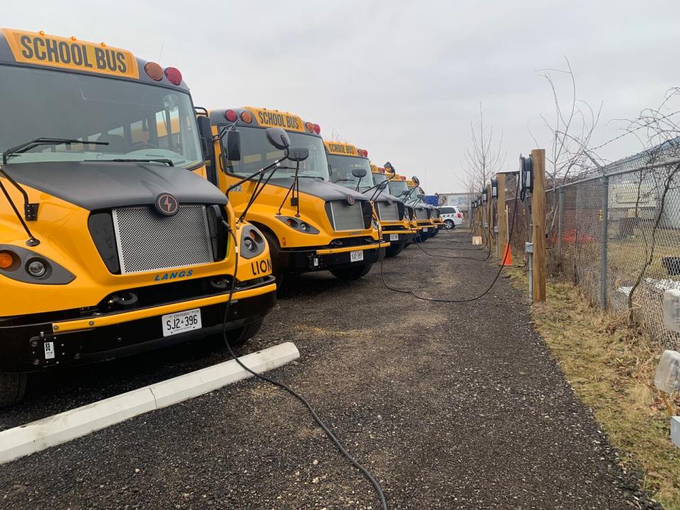 Electric school buses charge in the leadup to the return to classes at the Langs Bus Lines facility in south London.