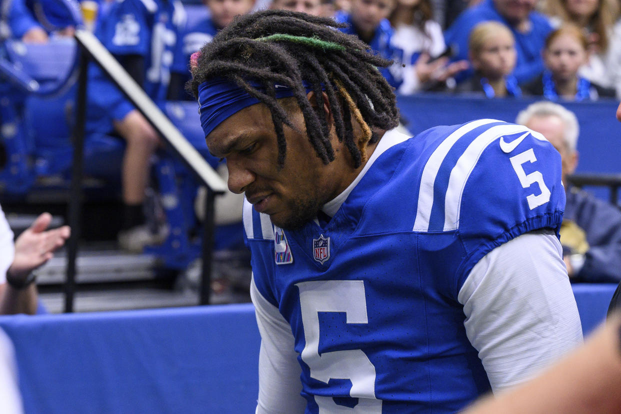 Anthony Richardson walks off the field after injuring his right shoulder. (AP Photo/Zach Bolinger)