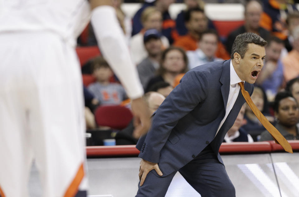 Virginia head coach Tony Bennett speaks to his players during the first half of an NCAA college basketball third-round tournament game against Memphis, Sunday, March 23, 2014, in Raleigh. (AP Photo/Chuck Burton)