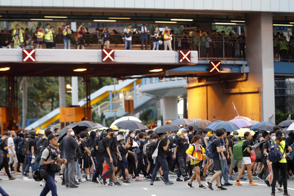 Protesters gather on a highway during a demonstration in Hong Kong, Saturday, Aug. 3, 2019. Hong Kong protesters ignored police warnings and streamed past the designated endpoint for a rally Saturday in the latest of a series of demonstrations targeting the government of the semi-autonomous Chinese territory. (AP Photo/Vincent Thian)