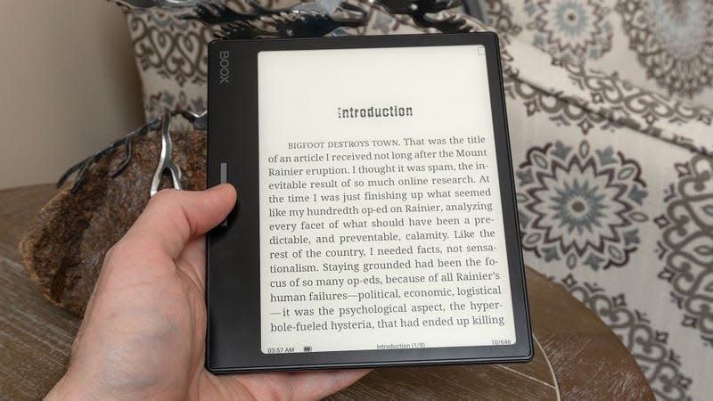 The Onyx Boox Leaf 2 held in one hand with an ebook displayed on screen.