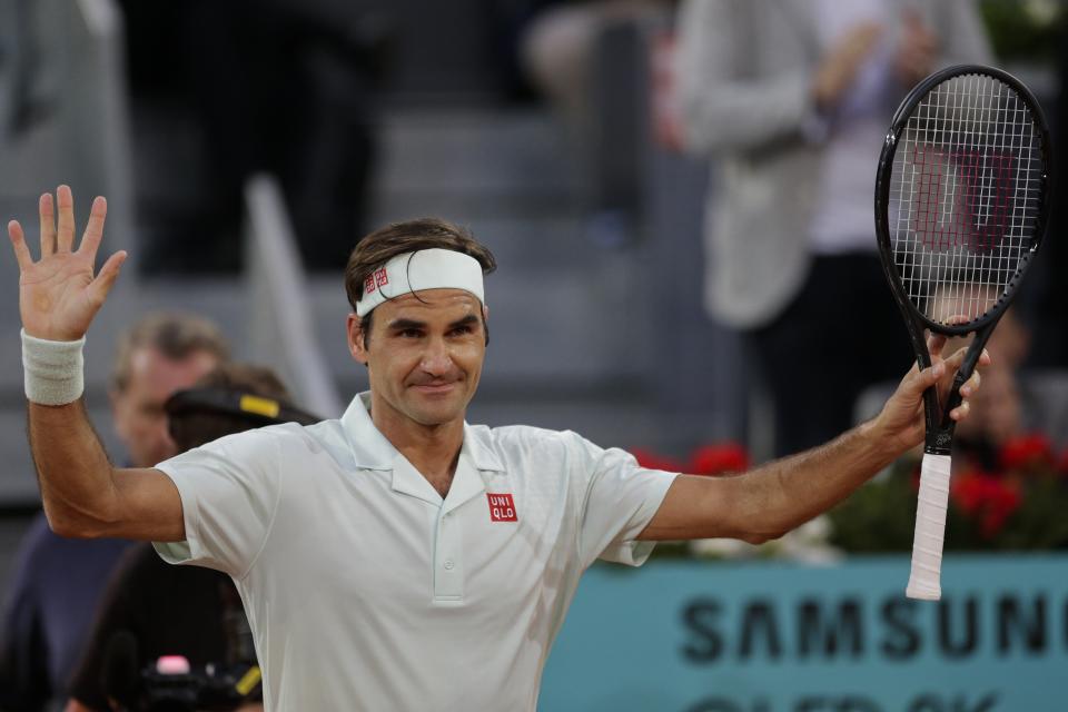 Roger Federer, from Switzerland, celebrates after winning right, embraces Richard Gasquet, from France, during the Madrid Open tennis tournament in Madrid, Tuesday, May 7, 2019. (AP Photo/Bernat Armangue)