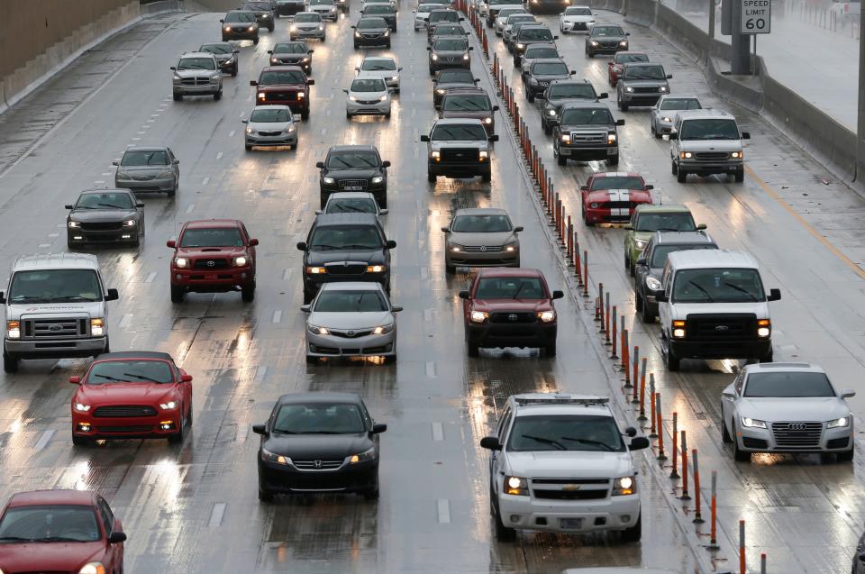 Drivers make their way in the rain along Interstate 95, Tuesday, Aug. 30, 2016, in Miami.