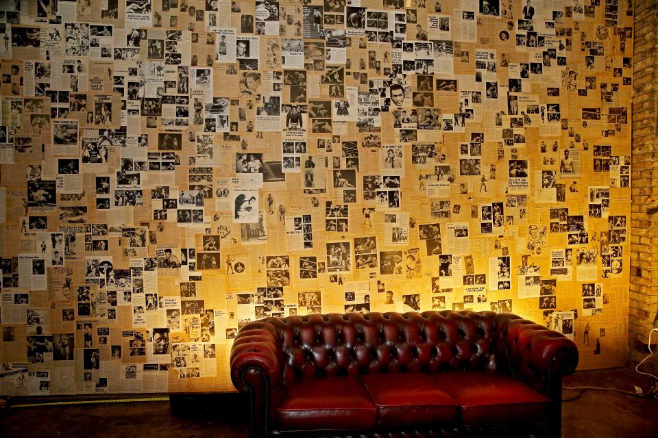 A collage of vintage Ring magazine clippings fills a wall at Dropout Fight Club, the Riverwest gym owned by Otto Ohlsson.