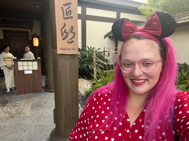 casey posing for a photo in front of Takumi-Tei restaurant in epcot at disney world