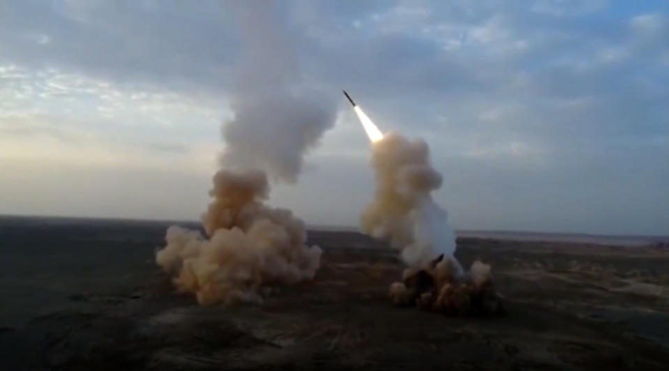 This video grab shows launching underground ballistic missiles by the Iranian Revolutionary Guard during a military exercise. Iran's paramilitary Revolutionary Guard launched underground ballistic missiles as part of an exercise involving a mock-up aircraft carrier in the Strait of Hormuz, state television reported Wednesday. (IRGC via AP)