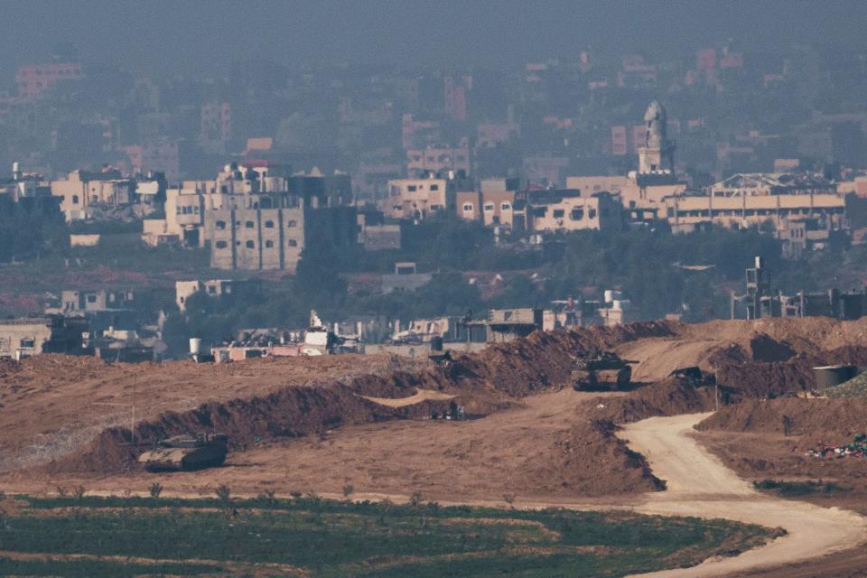 Israeli tanks stand on the border with the Gaza Strip, as seen from southern Israel, Monday, Jan. 1, 2024. (AP Photo/Leo Correa) ORG XMIT: XOB101