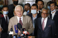 Former Malaysian Prime Minister Najib Razak speaks at the court house in Kuala Lumpur, Malaysia, Tuesday, July 28, 2020. A court has sentenced Najib to serve 12 years in prison after finding him guilty in the first of several corruption trials linked to the multibillion-dollar looting of a state investment fund that brought down his government two years ago. (AP Photo/Vincent Thian)