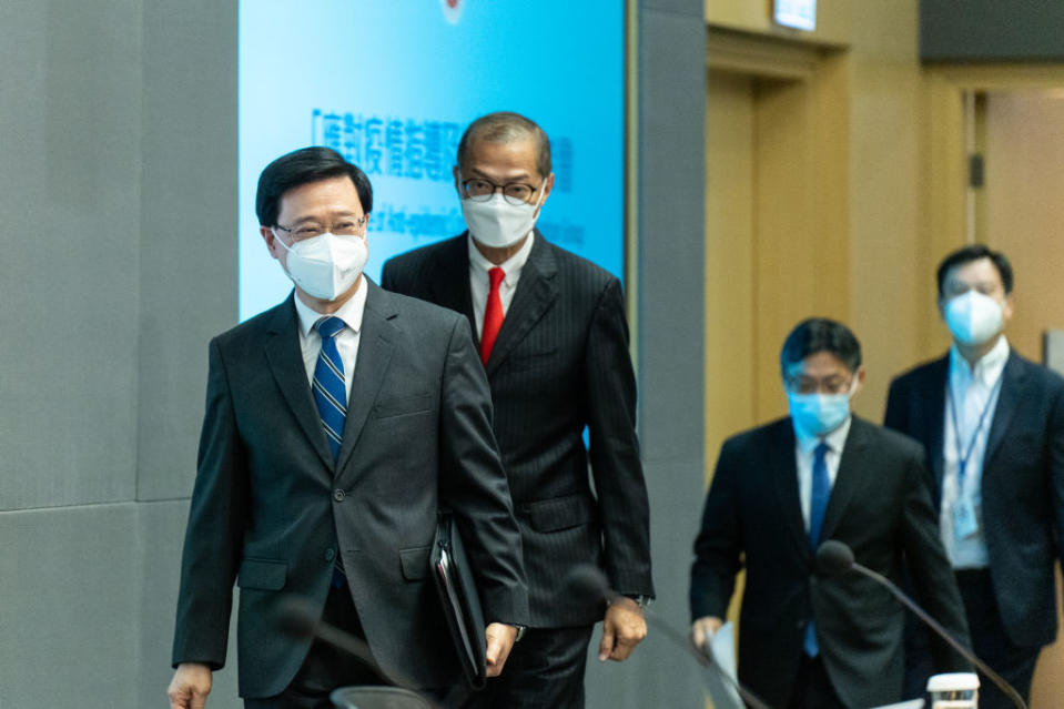 John Lee, Hong Kong's chief executive, left, and other officials arrive at a news conference to announce the end of hotel quarantine in Hong Kong, China, on Friday, Sept. 23, 2022.<span class="copyright">Chan Long Hei/Bloomberg via Getty Images</span>